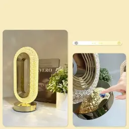 Close-up of a finger touching the blue illuminated button on the golden base to adjust the lighting