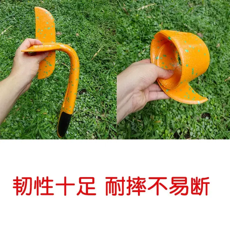 Person bending the orange foam glider plane to show its extreme flexibility and crash resistance